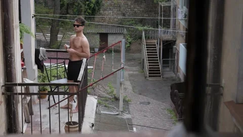 Man sunbathing on the balcony Stock Footage 195339535