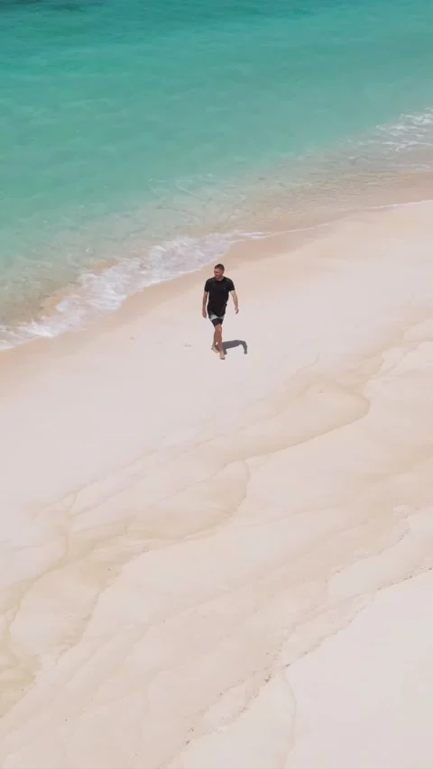 Man sunbathing on the beach.Vertical video Stock Footage 300660180