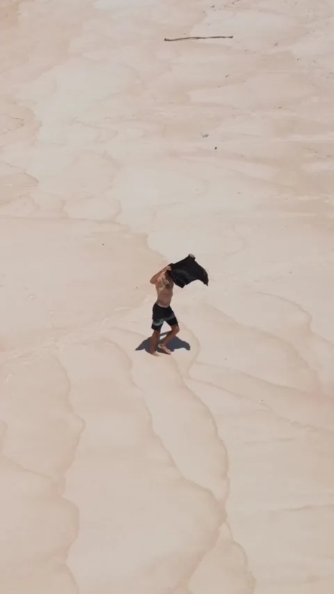 Man sunbathing on the beach.Vertical video Stock Footage 300660192