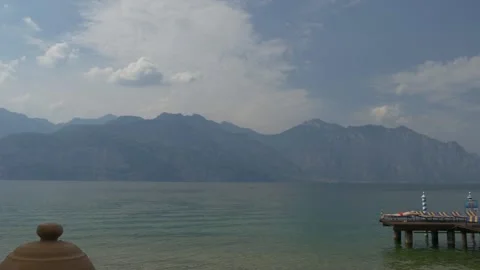 Man sunbathing next to Lake Garda Video stock 130949647
