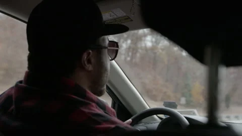 Man with Sunglasses and Cap Driving Car on Highway Stock Footage 343935597