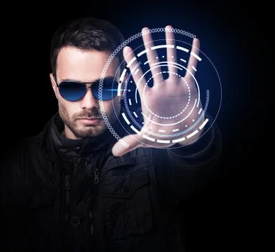 Man in sunglasses controls virtual system by hand. 스톡 사진