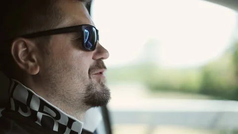 A man in sunglasses drives a car. Stock Footage 103301422