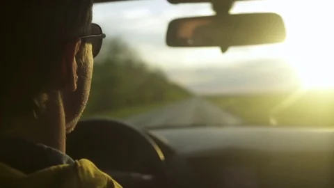 Man in sunglasses gesturing while driving a car 스톡 동영상 72505866