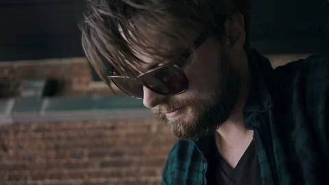 Man With Sunglasses Looking Down While Working On His Skateboard Video stock 133624994