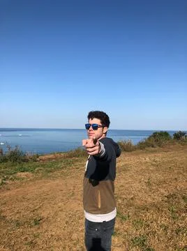 Man with sunglasses pointing to camera Stock Photos