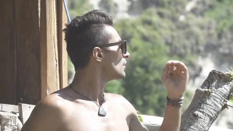 Man in Sunglasses Puts hand through Hair Slow Motion Stock Footage 106783877