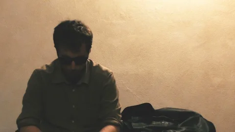 Man with Sunglasses Raises Head Stock-Footage 87204854