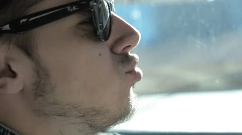 Man in sunglasses singing sitting behind the wheel Stock Footage 51756411