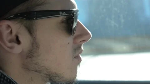 A man in sunglasses sitting in a car. Stock Footage 51756571