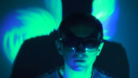 Man in sunglasses in the spotlight Stock Footage 71640070