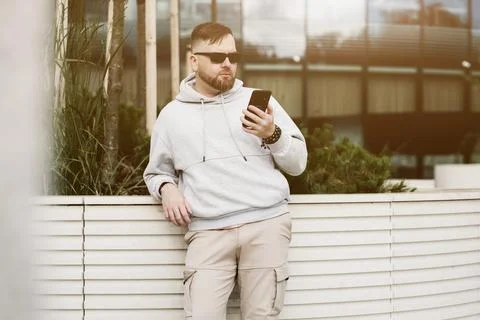 Man in sunglasses using cell phone gadget Stock Photos