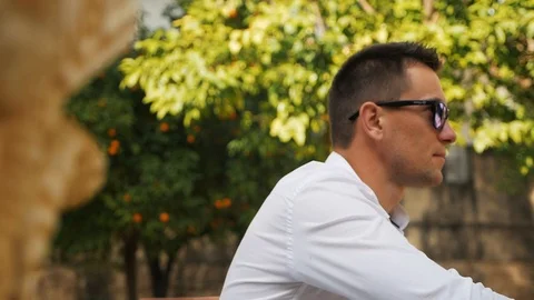 A man in sunglasses watches Stock Footage 87686876