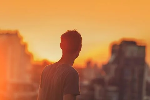 Man on the sunset background. Stock Photos