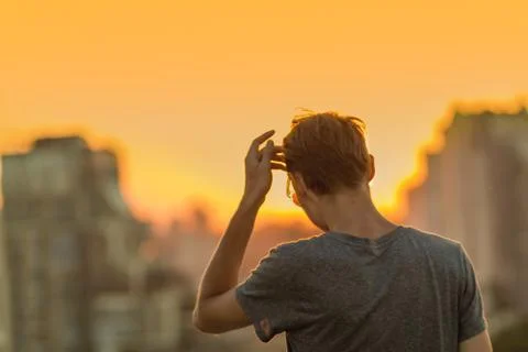 Man on the sunset background. Stock Photos