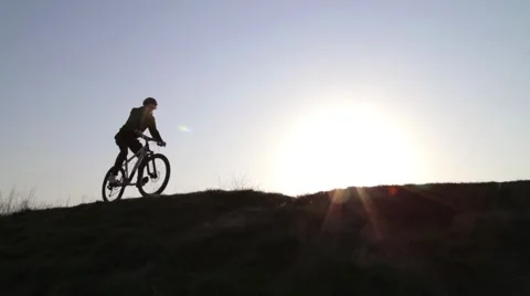 Man at Sunset on a Bicycle Stock Footage 63071824