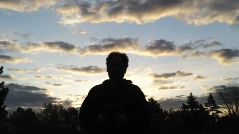 A man at sunset - Drone camera moves forward Stock Footage 137865703