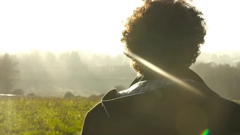 Man at sunset looking at the horizon with flare 스톡 동영상 73287648