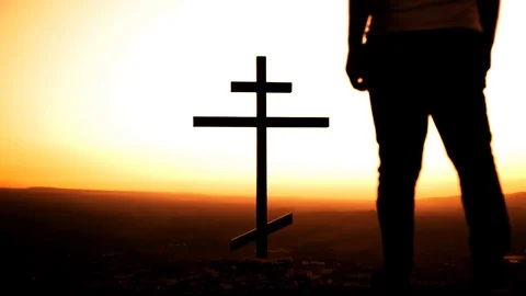 Man at sunset in the mountains goes to a religious cross Stock Footage 108188773
