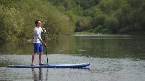 Man on sup board Stock Footage 244343924