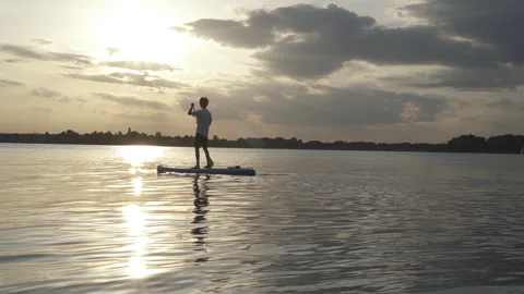 Man on the SUP board. Sunset Stock Footage 257724077