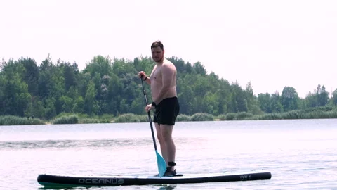 Man on supboard on the middle of the lake Video stock 246791898