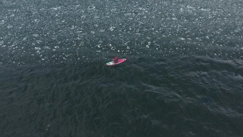 Man on supboard rowing intensely Stock Footage 189417418
