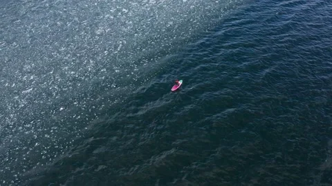 Man on supboard rowing intensely Stock Footage 191360002