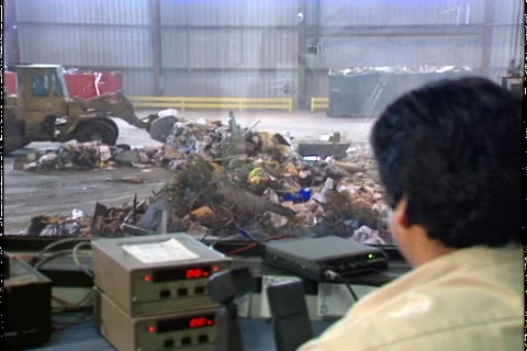 MAN SUPERVIZES GARBAGE LOAD Stock Footage 1052560