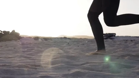 Man with surfboard running on beach in slow motion Stock Footage 71829384