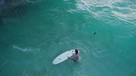 A man with a surfboard on the waves Stock Photos