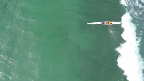 Man surfer with a kayak. Catching waves at sea Stock Footage 70402504