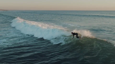 Man surfer riding sea wave in the golden evening light. Stock Footage 285730700