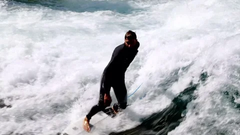 Man Surfer Riding the Wave on River Aare in City of Thun in a Sunny Summer Day Video stock 265486167