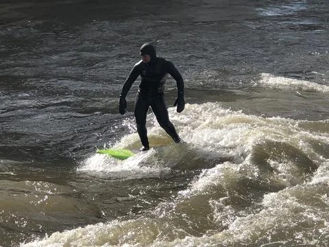 A man is surfing the Bow River currents in Calgary, Alberta Stock Photos