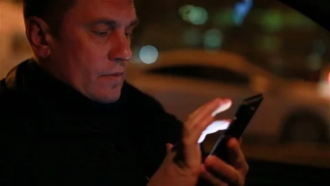 A man surfs the Internet in a smartphone Stock Footage 98207665