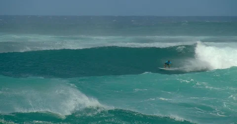 Man Surfs Large Wave in Crystal Blue Hawaii Ocean, Slow Motion Stock Footage 127517476