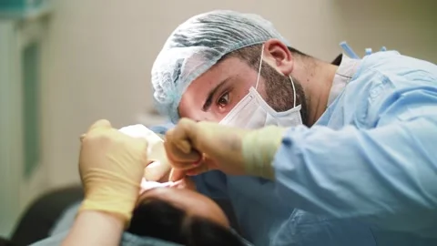 A man surgeon performs face and hands surgery close-up Stock Footage 160939024