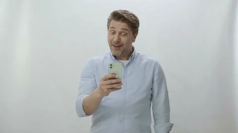 The man is surprised and happy when he receives a news or message on his phone. Stock Footage 198360110