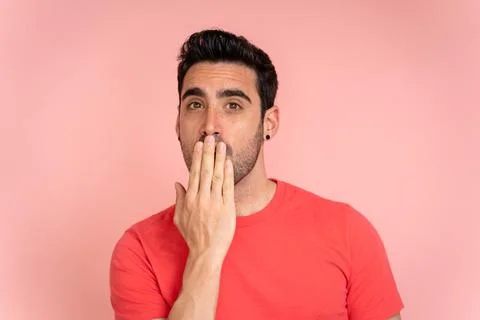 Man with surprised expression in studio shot. Stock Photos