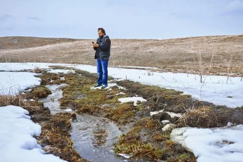 Man at the swamp using geolocation on smartphone Stock Photos