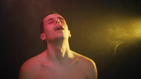 Man sways euphorically in altered state under neon lights 스톡 동영상 312475226