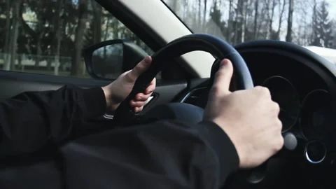 Man in sweater is sitting in the car behind the wheel. driver is driving the car Stock-Footage 336265146