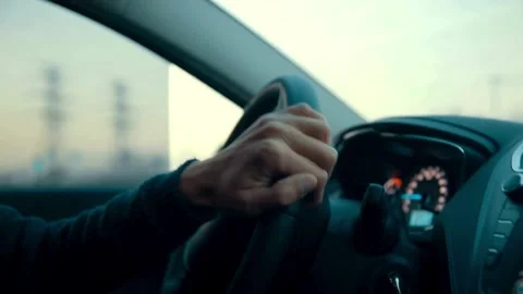 Man in sweater is sitting in the car behind the wheel. driver is driving the car Stock-Footage 336265407