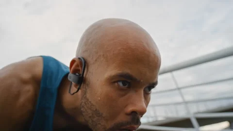 Man, sweating and start running in city with earphones, intense exercise or Stock Footage 331347278