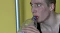 Man sweating, having a drink HD Footage