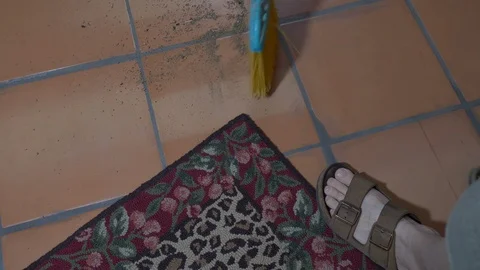 A man sweeping dirt under the rug Stock Footage 96087095
