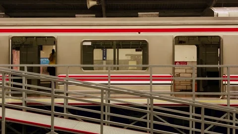 A man sweeping the floor inside the Commuter Rail. 動画素材 273992391