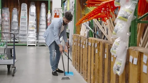Man sweeping floor in a large hardware store 動画素材 336965704