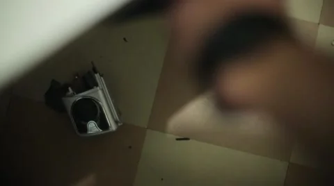 Man sweeping fragments of broken record player on floor by  broom. Top view Stock Footage 60374546